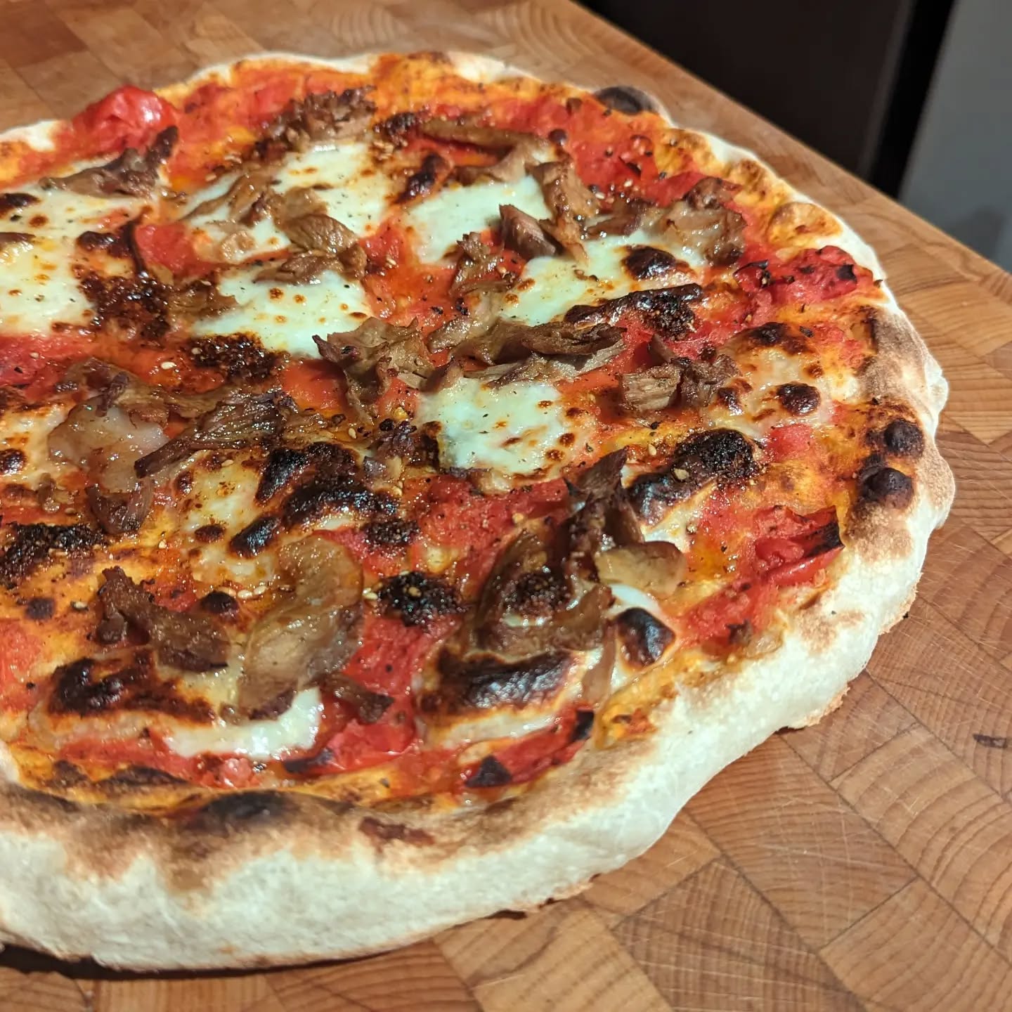 My pizza oven stone got broken by my cat making a particularly adventurous leap onto the greenhouse shelf. She got a nice hour or two in the sun, my pizza oven hasn't been used since. I bought some Caputo flour recently and after a couple of failed BBQ pizza attempts, I went back to the method of pizza I used when I got started on the journey. The method is simply: preheat a griddle pan over the gas for 5 minutes or so, when it's ready, turn an oven grill on too. Stretch the pizza dough (it doesn't have to be fully), and drop it on the pan.